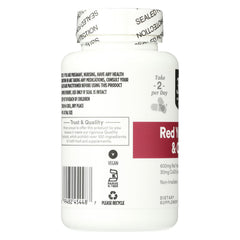 Pouring 365 Red Yeast Rice with CoQ10 capsules from the bottle.