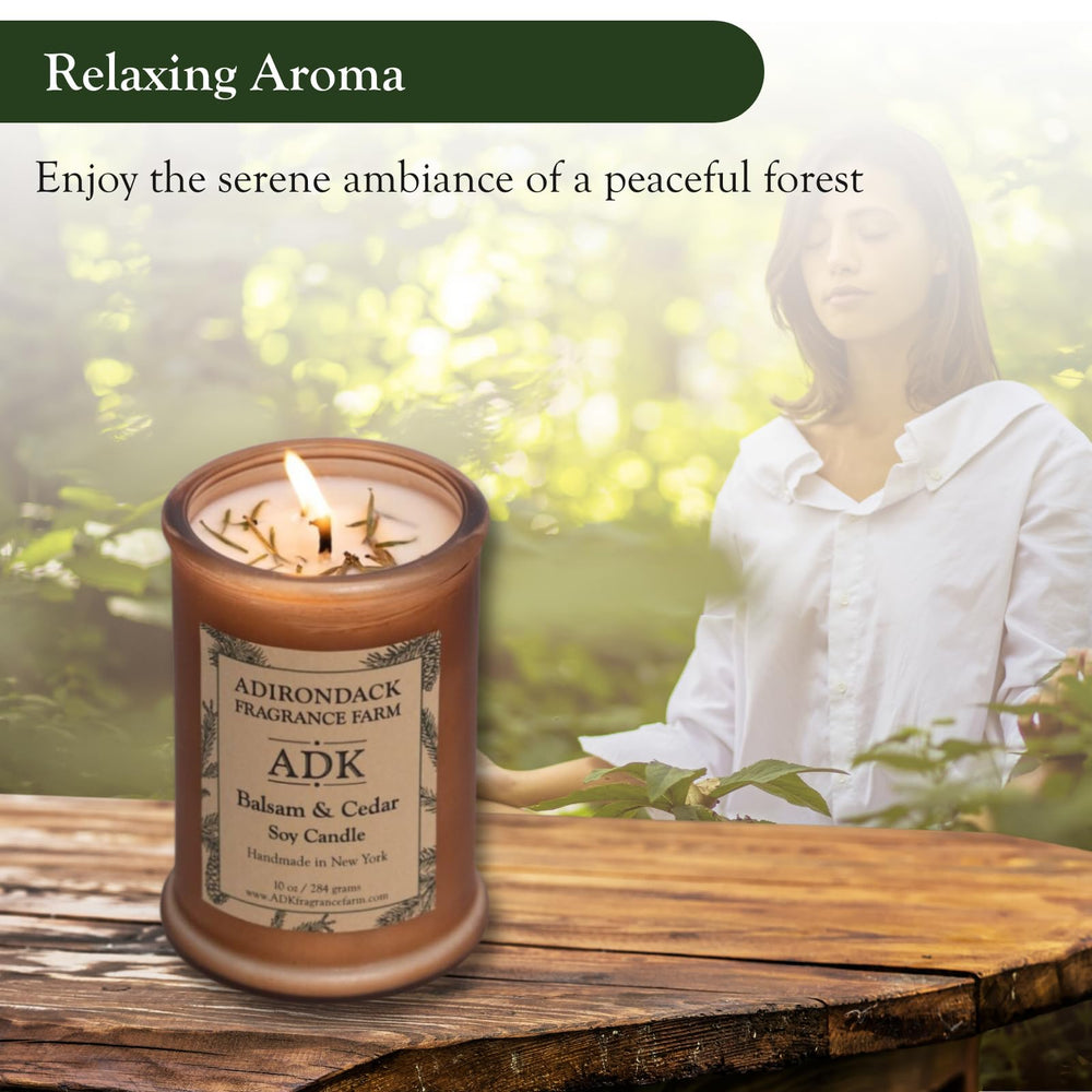 ADK woodsy-aroma-candle enhances relaxation with cabin-inspired fragrance.