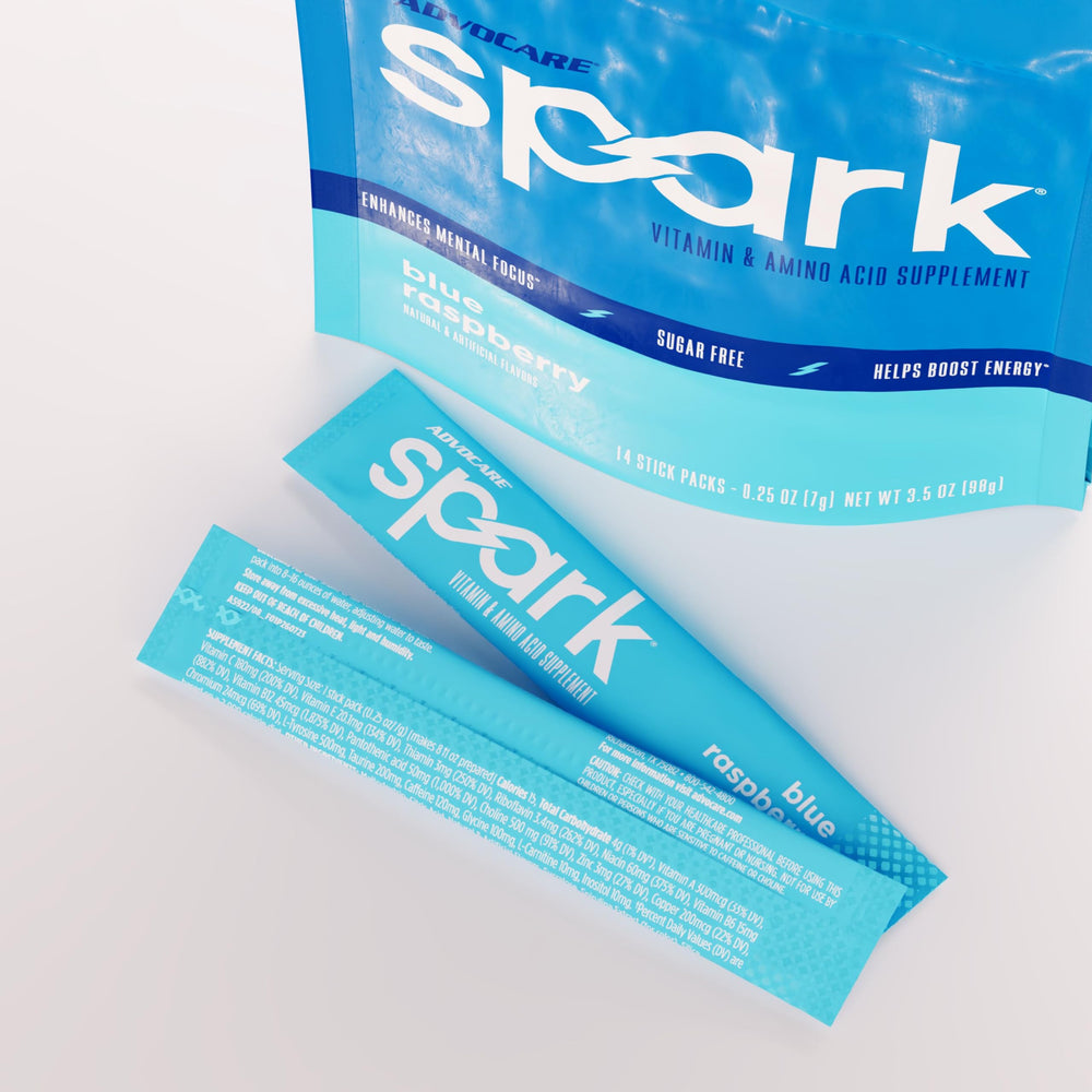 AdvoCare Spark blue raspberry powder dissolving in water for a flavorful energy lift.