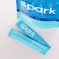 AdvoCare Spark blue raspberry powder dissolving in water for a flavorful energy lift.