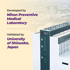 AFC Japan Ultimate Vision 4X bottle on a desk beside a computer.