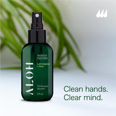 A spray mist being applied to the hand with ALŌH bottle