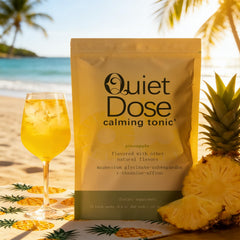 AMUA Quiet Dose glass with pineapple drink ready for relaxation.