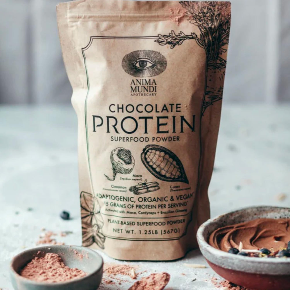 Scoop of Anima Mundi chocolate protein powder for smoothie prep