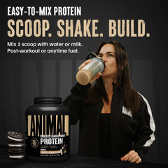 Scoop of Animal Whey Isolate showing powder texture and label