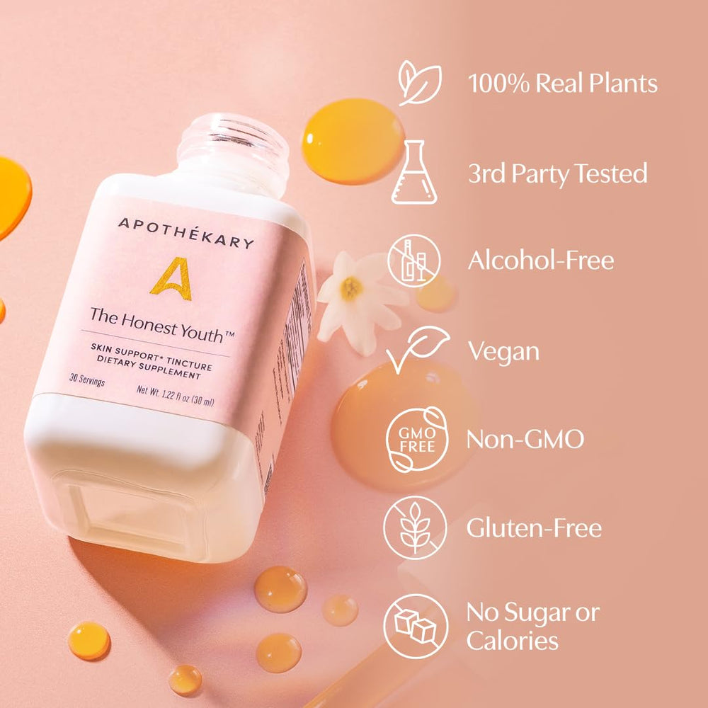 Peach flavored The Honest Youth drops sit beside a glass for daily use.