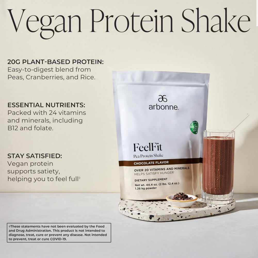Arbonne Feelfit chocolate pea protein shake in a glass for energy and daily nutrition
