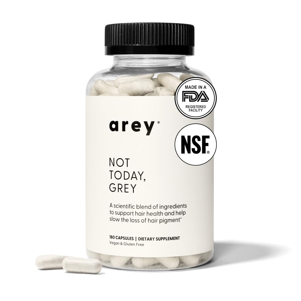 Arey Not Today capsules arranged for daily intake to potentially slow greying.