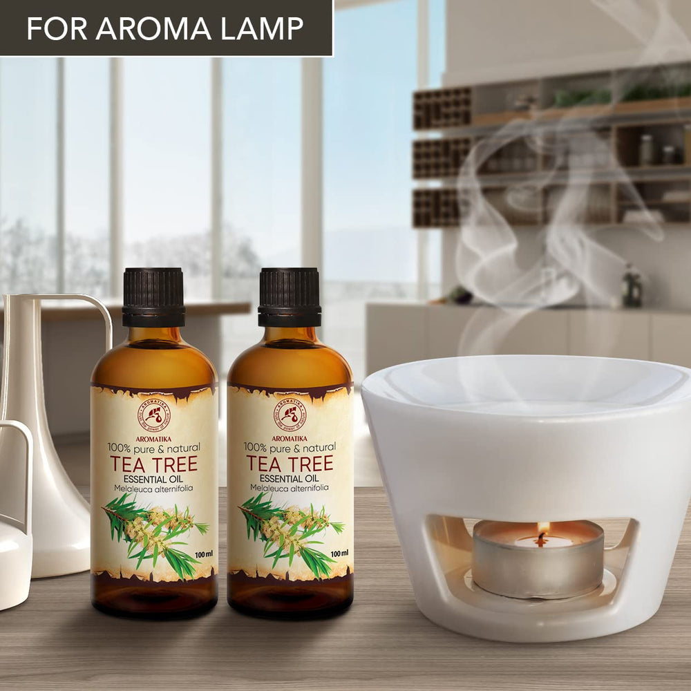 AROMATIKA Tea Tree Oil bottle top view highlighting premium pure oil usage.