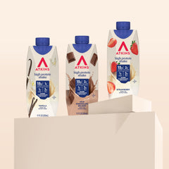 Smooth pour of Atkins shake into a glass, creamy texture showcased