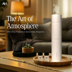 Aura House diffuser on a wood base creates balanced ambient scent in living spaces.