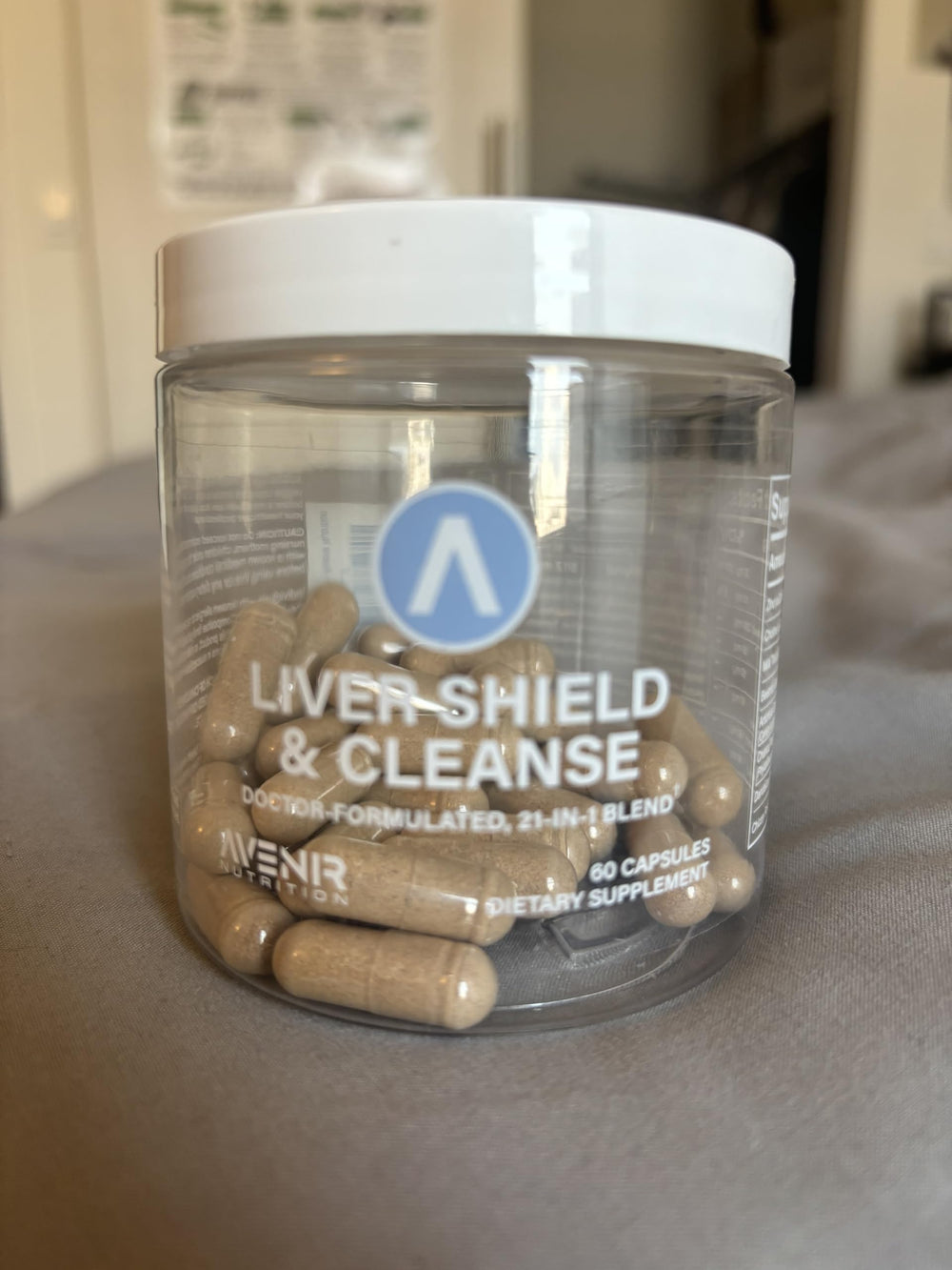 Avenir Liver Shield bottle on counter with herbal imagery suggesting detox benefits