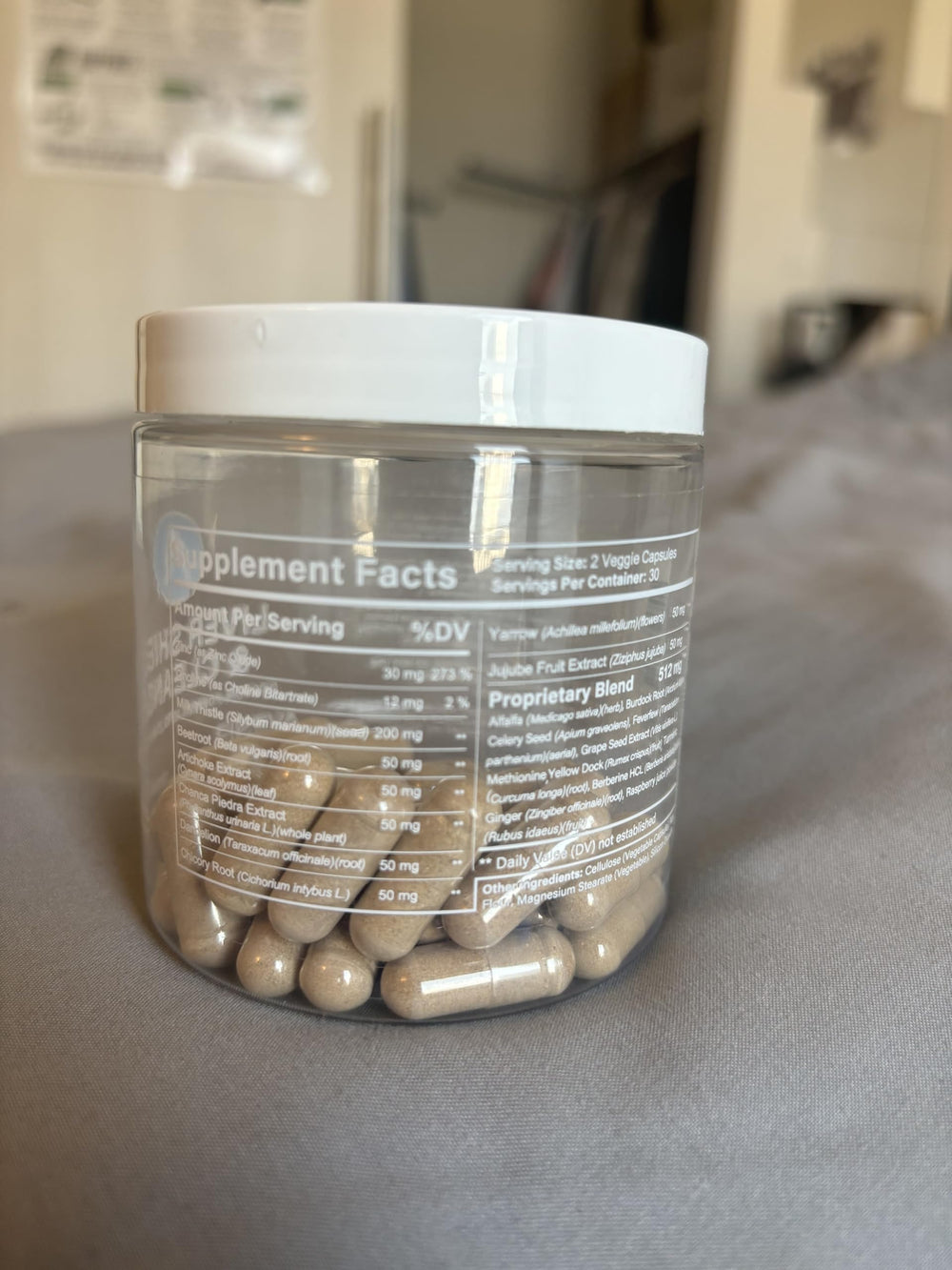 Avenir Liver Shield capsules arranged with fruits and greens for everyday wellness