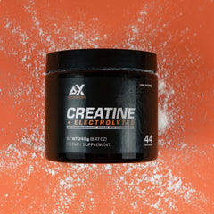 AX Nutrition Creatine + Electrolytes powder scoop prepared for a pre-workout serving.