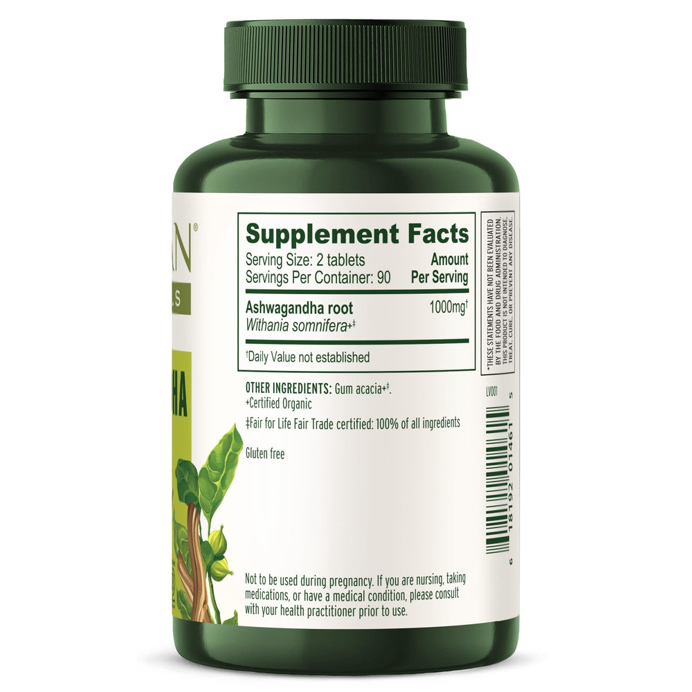 Banyan Botanicals Ashwagandha tablets beside water for sleep support.