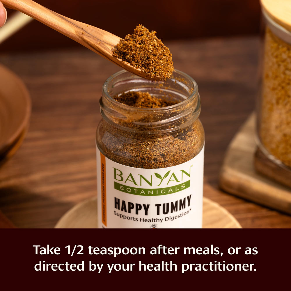Banyan Botanicals Happy Tummy glass bottle label on organic herbs.