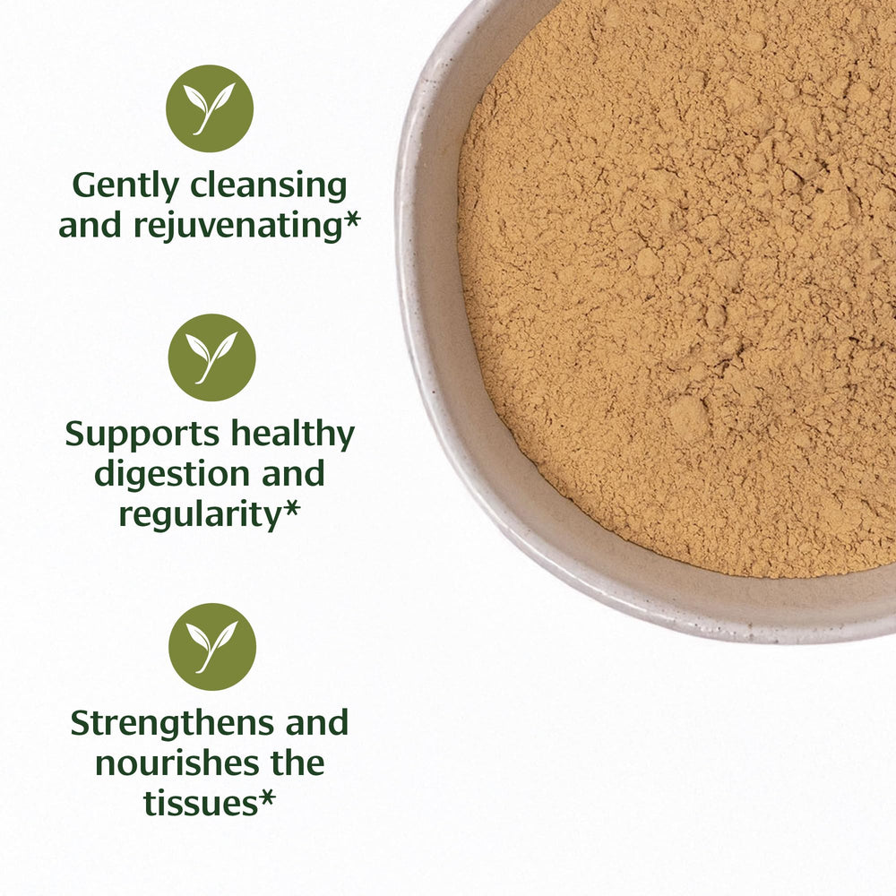Banyan Botanicals Haritaki powder with measuring scoop for precise dosing.