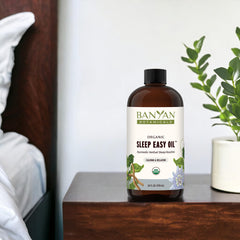 Sleep Easy Oil with ashwagandha and chamomile beside the bottle, highlighting natural ingredients