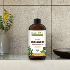 Pouring Banyan Botanicals Vata oil for a silky skin massage