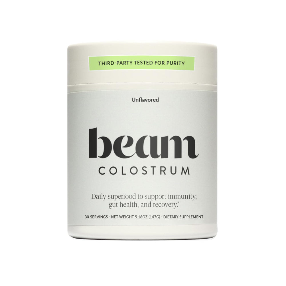 Beam Colostrum Powder jar pour: grass-fed formula supports gut health and daily wellness.