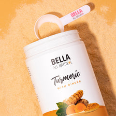 Close-up of Bella All Natural turmeric-ginger powder with spoon