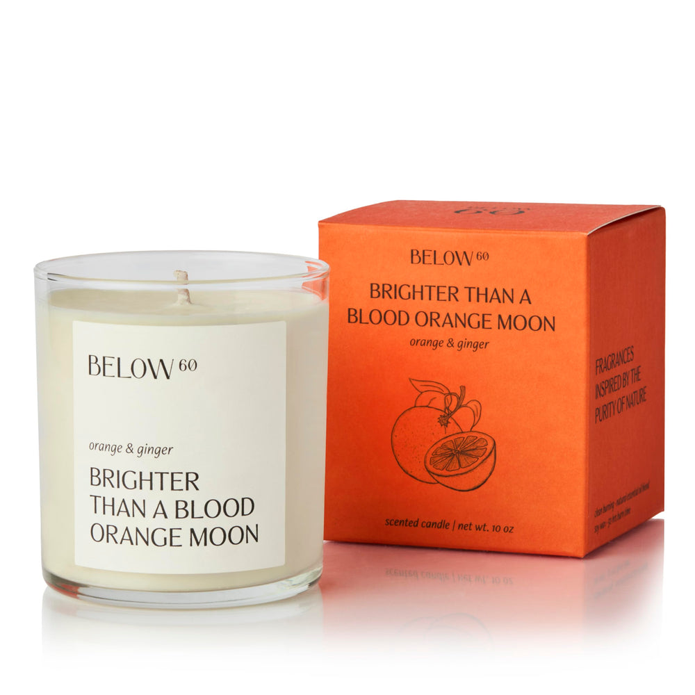 Below 60 blood orange ginger candle lit to enhance focus