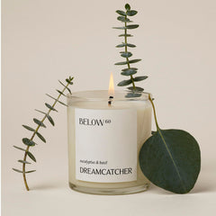 Below 60 Dreamcatcher candle close-up of label with warm glow for a clean, soothing burn.