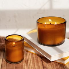 Amber glass vessel from Bluecorn Beeswax candle on a shelf or coffee table