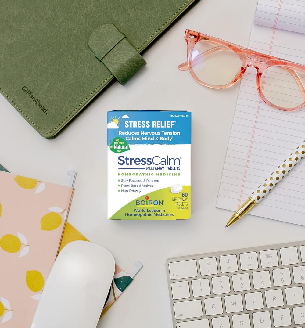 Boiron StressCalm product in use at a desk during a busy day.