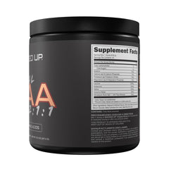 Peach Ring Bucked Up BCAA scoop dissolving in water for workouts.