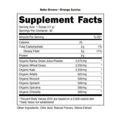 Bottle of Bucked Up Organic Greens Orange Sunrise beside fresh fruit for easy daily intake.