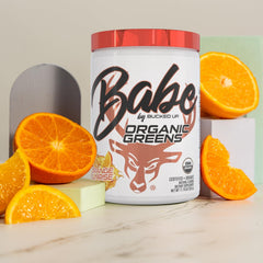 Close-up of Bucked Up Greens Orange Sunrise powder mixing smoothly into a protein shake.