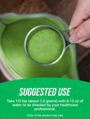 BulkSupplements Organic Wheatgrass Powder glass jar on kitchen counter for daily wellness.