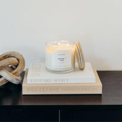 Soft ambient glow from Aspen & Fog candle in a cozy room.