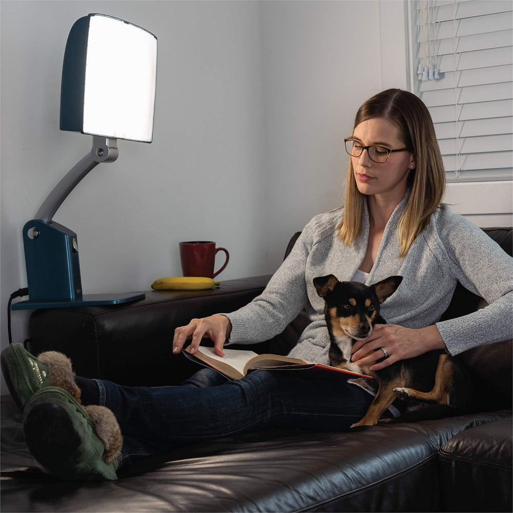 Carex Day-Light Sky height-adjustable stand enables comfortable desk placement.