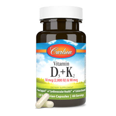 Carlson D3 K2 bottle on desk with glass and plant