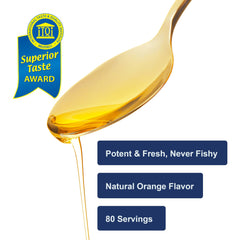 Carlson Kids orange liquid being measured with dropper for half-teaspoon dose