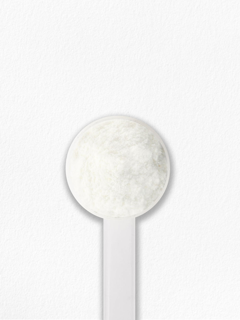 Carlyle Multi Collagen Powder with scoop beside glass of water.