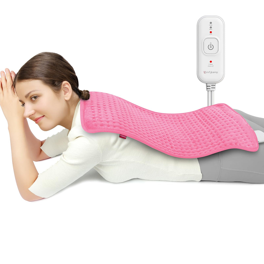 Comfytemp heating pad on couch covering back and shoulders for muscle relaxation.