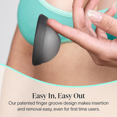 Cora Menstrual Disc Charcoal insertion view shows the finger groove aiding insertion.