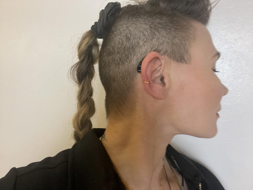 Deafmetal no piercing solution keeps hearing aids in place without piercings.
