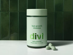 Divi Hair Growth Vitamins on a sink setup illustrates practical daily self-care