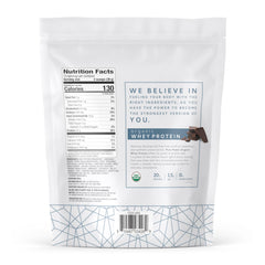 Scoop pouring into a shaker with Dr. Mercola Pure Power Organic Whey for convenient daily protein
