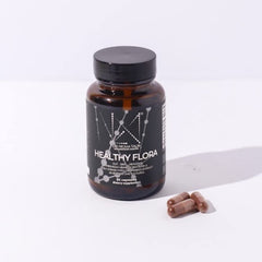 DR. NIGMA Healthy Flora capsules in hand for daily gut support