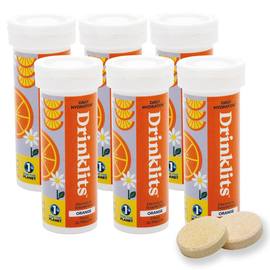 Drinklits orange electrolyte tablet dissolving in glass for refreshing hydration
