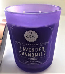 DW Home lavender chamomile candle on table enhancing relaxing ambience with bergamot notes.