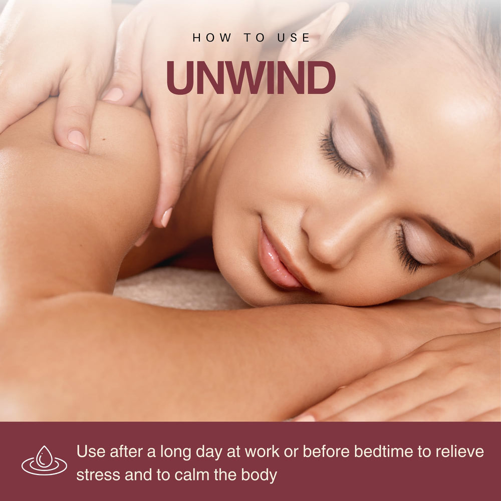Enhanced Essentials Unwind amber bottle on bed for date-night prep