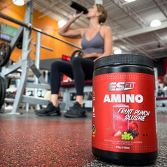 Pouring ES FIT Amino Powder for quick hydration during training.