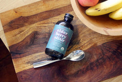 Fields Without Fences eco-packaging with recyclable glass and post-consumer labels.