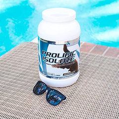 G6 Sports Prolific Isolate 25g scoop beside jar.